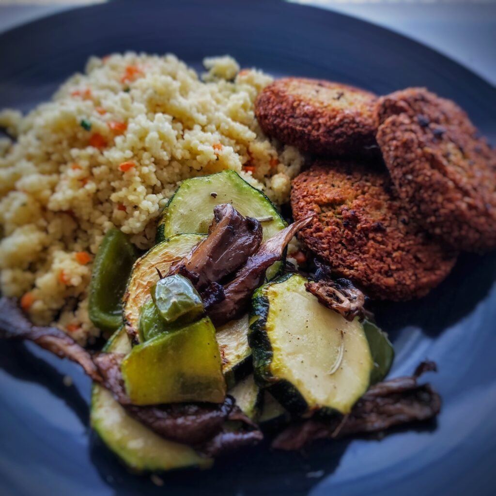 a plate of food with meat patties and rice